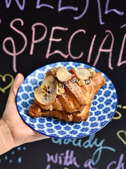 A beautiful Pear-Chocolate-Almond Twice-Baked Croissant, perfect for a rainy day. The combination of sweet pear, rich chocolate, and nutty almond is simply irresistible.