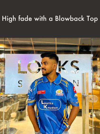 This High Fade with a Blowback Top is a popular and versatile men's hairstyle. The high fade keeps the sides neat, while the voluminous top adds a touch of modern flair, perfect for any occasion.