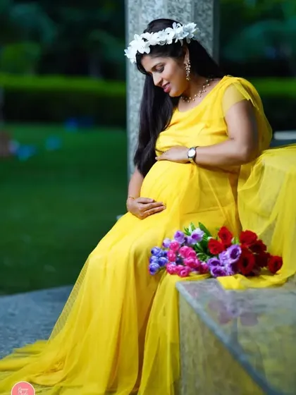 Sunshine in human form. A beautiful mother-to-be in a bright yellow gown, captured in a quiet moment of reflection during an outdoor session.