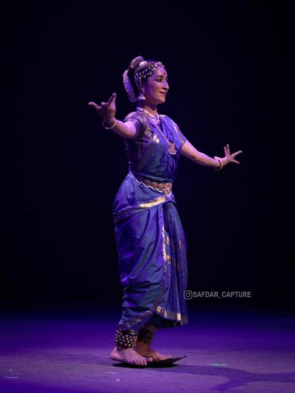 Dancing on the brass plate, seen from the side. This angle shows the precision required to maintain balance while moving.