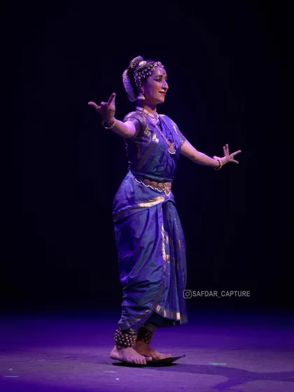 Dancing on the brass plate, seen from the side. This angle shows the precision required to maintain balance while moving.