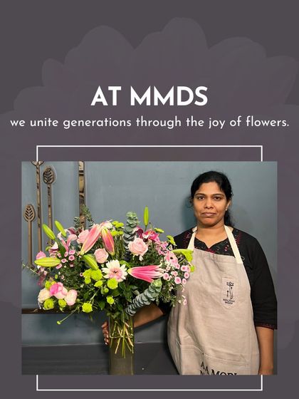 A student stands proudly with her large, elegant arrangement of lilies and roses. This is a classic example of the beautiful work produced in my classes.