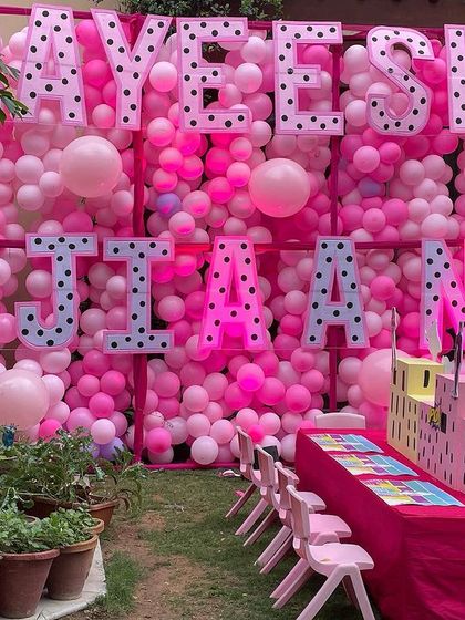 For a girly superhero party, I created this massive balloon wall in shades of pink as a backdrop. The polka-dotted letters spelling out the birthday girls' names add a fun, playful touch.