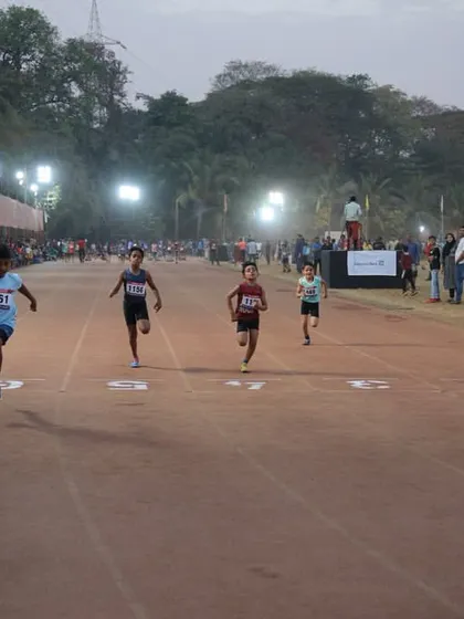 Young sprinters race towards the finish line during a TrackNights event. It's a platform for athletes of all ages.