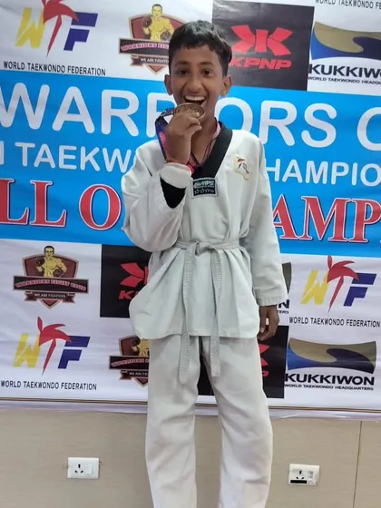 The joy of winning a medal. This young student's smile says it all after his victory at the Warriors Cup.