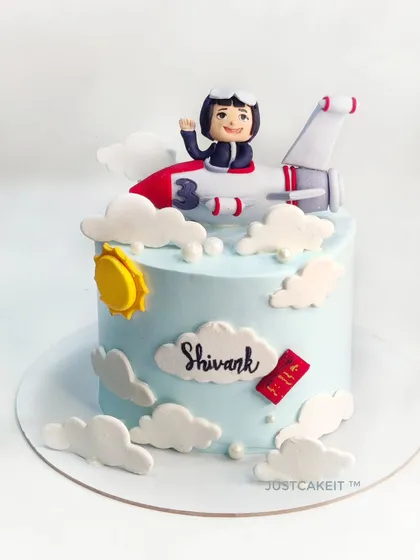 A cute little pilot theme cake, with an edible plane and pilot figurine flying above the clouds. This was a signature chocolate truffle cake inside.