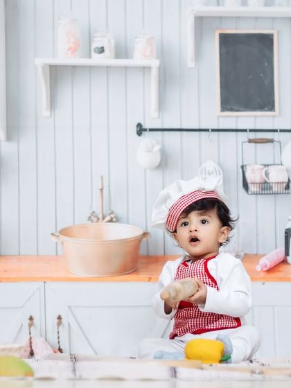 A love story waiting to be told. A little chef explores the ingredients in our charming kitchen studio setup.