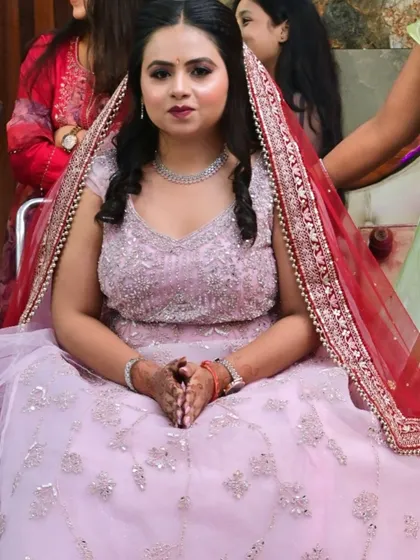 An engagement beauty in a lovely pink gown. The makeup is soft and doll-like, with a hint of sparkle on the eyes.