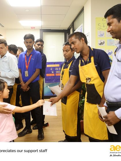 A small gesture of appreciation. A student gives a thank you card to a staff member, learning that kindness and service are important values in our school community.
