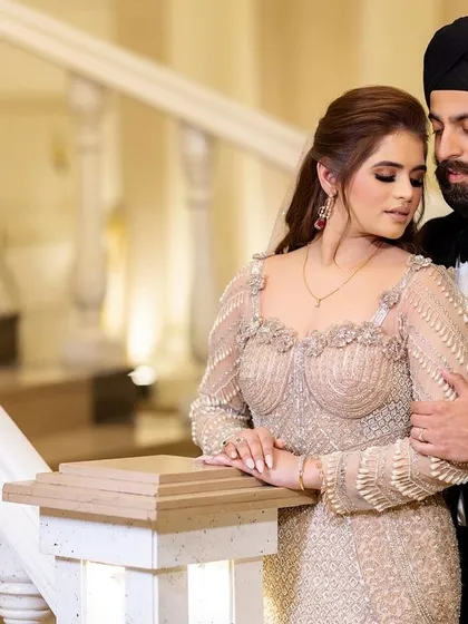A quiet, posed moment for Sahib and Muskan on the stairs. We use the elegant interiors of the venue to create sophisticated portraits during the cocktail event.