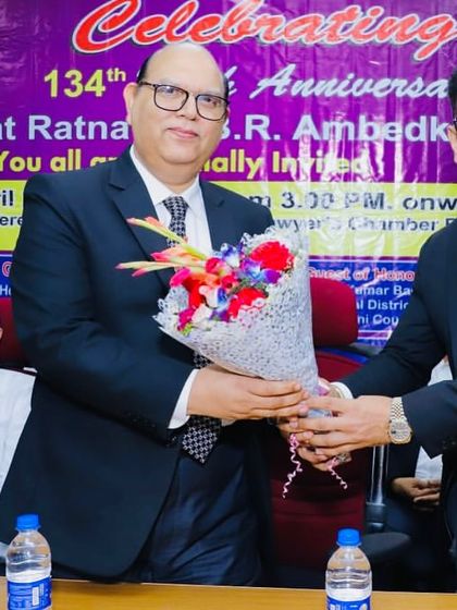 Welcoming a senior judicial officer with a bouquet at the Dr. Ambedkar Jayanti event.