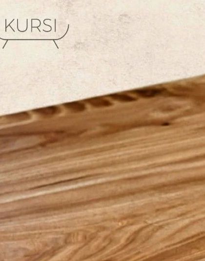 The smooth, polished surface of a live-edge teak tabletop. It's where the raw beauty of the wood meets refined craftsmanship, creating a surface that is both beautiful and functional.