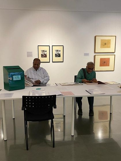 The library table at the 'Hand Prints' exhibition, where visitors can browse books, art journals, and poetry related to the artist's work.