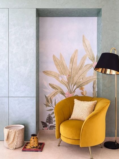 The full composition of the foyer niche, with the vibrant yellow armchair, black floor lamp, and tropical wallpaper creating a stylish and welcoming vignette.