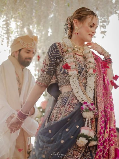 A beautiful candid of the bride during her Pheras, with the groom just behind her.