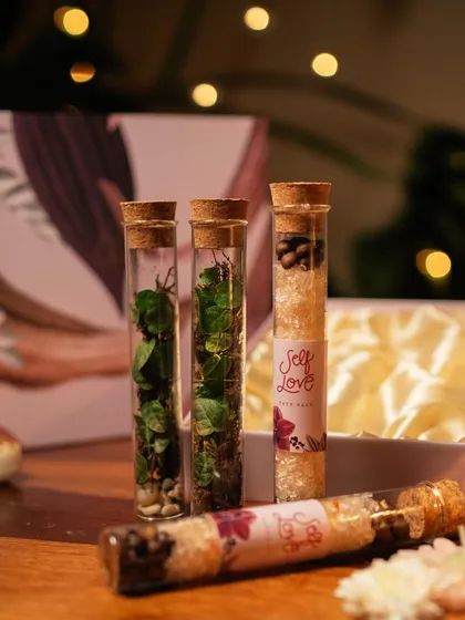 Here are the four stylish test tubes from my Diwali gift box. Two hold tiny living ecosystems, while the other two are filled with all-natural coffee and vanilla bath salts for a moment of self-love.