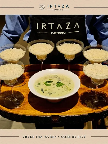 A serving of aromatic Green Thai Curry with Jasmine Rice, presented on a rustic wooden tray by my staff. This shows my expertise in authentic international cuisines, served with elegance.