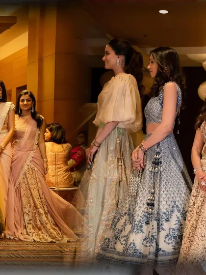 A candid shot of the beautifully dressed bridesmaids and guests enjoying the wedding ceremony.