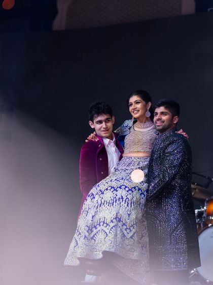 Carrying the love of their lives, quite literally. This super cute bride performing with her brother and her partner created a beautiful and memorable family moment.
