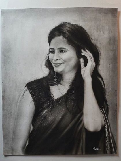 A charcoal and graphite portrait of a woman in a saree on A3 ivory paper. I focused on capturing the soft texture of the fabric and her serene expression.