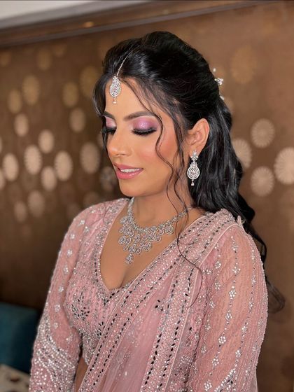 A side view of Garima's engagement makeup, showing the beautiful blend of the eyeshadow and the soft waves in her hair.