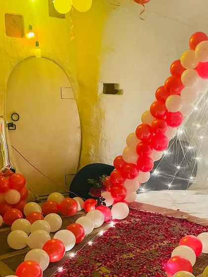 Another angle of the rustic 21st birthday, showing the fairy light tent and the balloon arrangement with the foil number balloons.