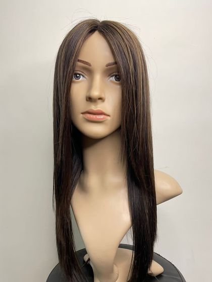 A straight-on view of our mono base hairpiece. The quality of the 100% real human hair is evident in its shine and flow.