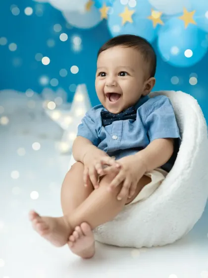 Look at that happy laugh. Milestone sessions like this half-birthday shoot are perfect for capturing your baby's growing personality as they sit up and explore the world.