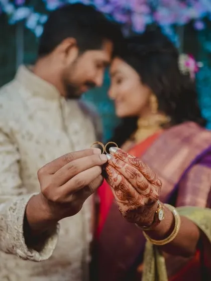 A creative shot where the couple holds their engagement rings together, with them as a soft focus in the background. It’s a symbolic photo that highlights both their commitment and their connection.