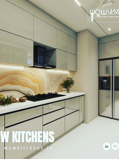 Another angle of the beige kitchen with the stunning onyx-patterned backsplash, showing the sleek, handleless design and integrated chimney.