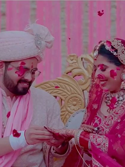 A playful moment during the wedding ceremony, with the couple covered in flower petals, their happiness shining through.