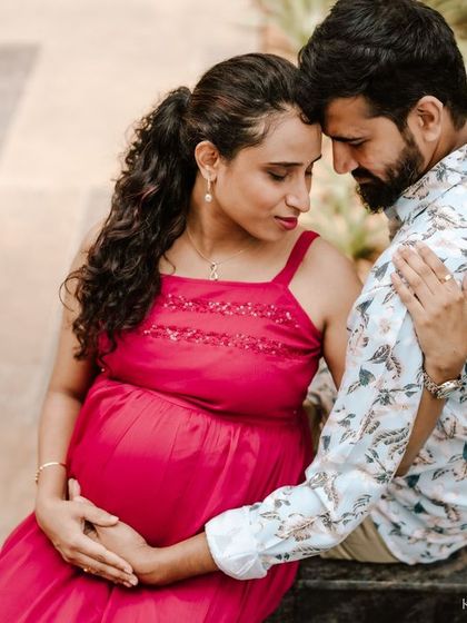 A tender moment between an expecting couple during an outdoor shoot. The way they connect, forehead to forehead, tells a story of partnership and shared excitement for their journey into parenthood.