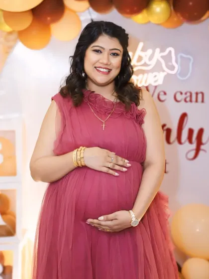 A full-length view of our wine-colored ruffled gown, showing how its gentle layers create a flattering A-line silhouette perfect for a baby shower.