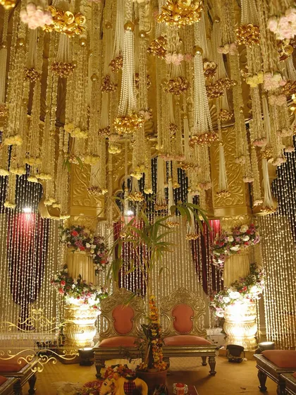 The view from within the mandap, where the couple is surrounded by a ceiling of cascading floral and pearl strings. This detail ensures that every angle is breathtaking, both for the couple and in their wedding photos.