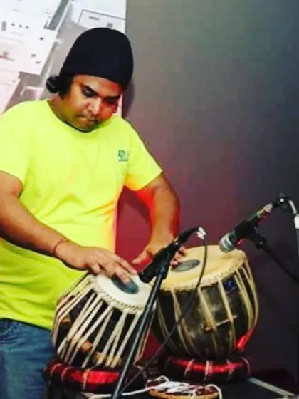 A candid shot from a live fusion gig. The casual attire and stage setup reflect the modern, experimental nature of these performances where I mix tabla with different genres.