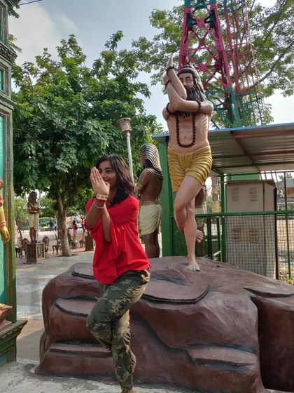 Trying out Garudasana (Eagle Pose) next to this yogi. It's a great pose for improving balance and concentration.