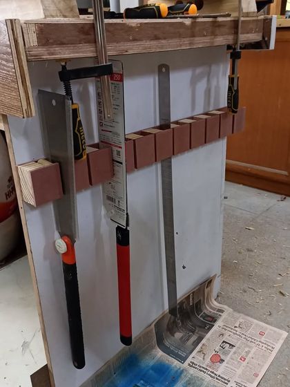 The saw till mounted on the side of my workbench, holding saws and clamps. Good organization is key to a safe and efficient workspace.