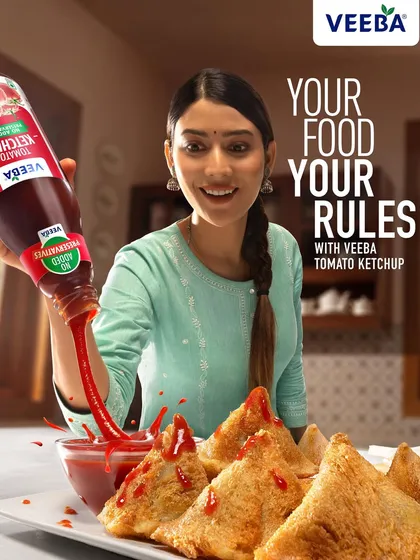The final ad layout for the Veeba ketchup campaign, combining the action shot with the brand's tagline. This version shows how the photography works within a complete advertisement to communicate a clear, powerful message.