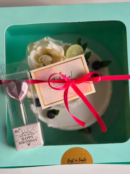 Here's how my signature Lemon Blueberry cake looks when it's all packed up and ready to go, complete with a candle and thank you card for your special occasion.