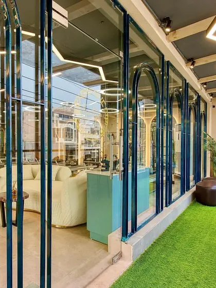 A look from the balcony into the bright, open studio space. The design uses glass and light to create an energizing and inspiring environment for your workout.