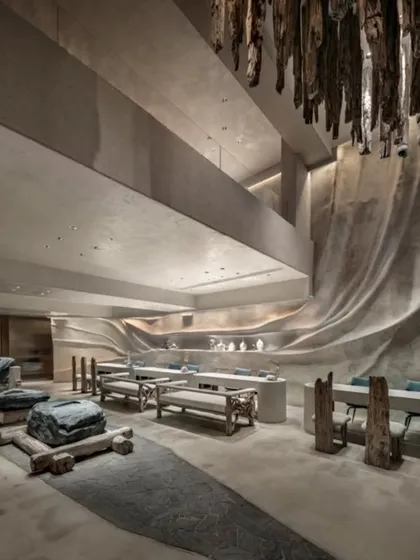 For the La Solitaire jewellery showroom, I wanted to create a space that felt like discovering treasure within the earth. This view shows how we used a driftwood chandelier, sculptural stone seating, and fluid, cave-like walls to craft a retail experience that is about contemplation and raw, natural luxury.
