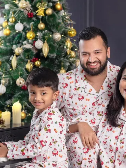 A lovely family portrait by the piano, all dressed in matching Christmas pajamas, ready to sing some carols.