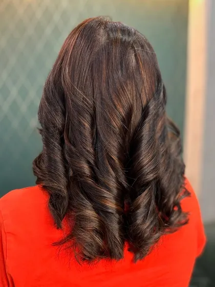 These natural brown hues are timeless. We added subtle highlights to give the hair a dimensional glow, styled in classic, defined curls.