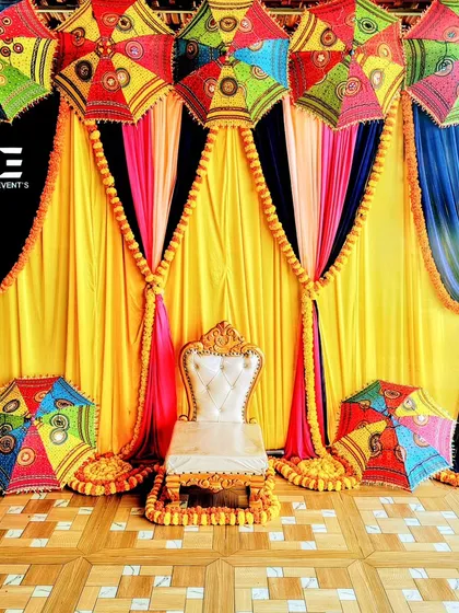 This vibrant Mehendi setup is all about celebrating with color and tradition. I used bright yellow and blue drapes, traditional Rajasthani umbrellas, and marigold garlands to create a festive and joyful atmosphere for the ceremony.