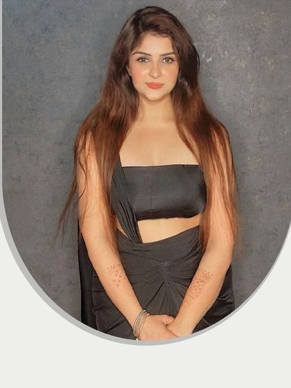 The black dress styled as a bandeau top with the drape over the arms, showing another versatile way to wear it.