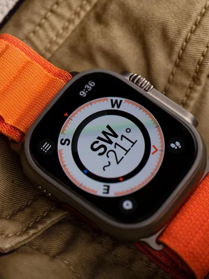 This lifestyle shot for the Apple Watch Ultra places the product in its intended environment. By showcasing the compass feature against an adventurous, textured background, we tell a story of utility and ruggedness that a simple studio shot cannot.