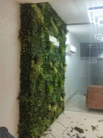 An in-progress shot of a vertical garden installation in an office, showing how we build it panel by panel.