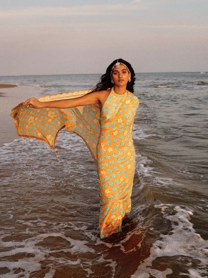 The full look of our pearl teeka with a beautiful printed saree, perfect for a destination wedding.