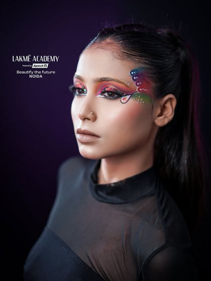 A powerful and direct look from the model, showcasing the confidence that comes with wearing such a bold and artistic makeup style.