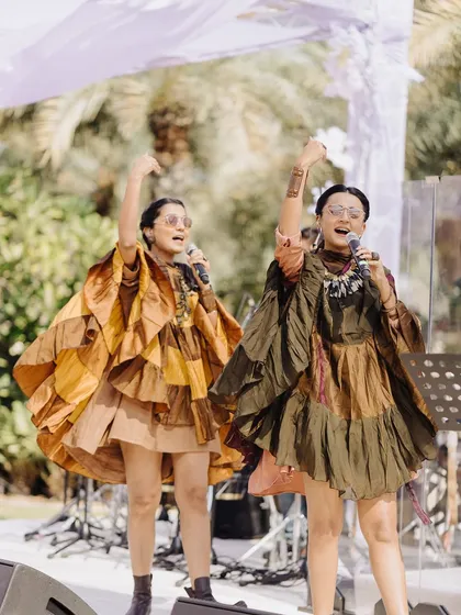 A live performance by a female duo in unique, fashion-forward outfits, bringing a cool and contemporary vibe to the celebration.